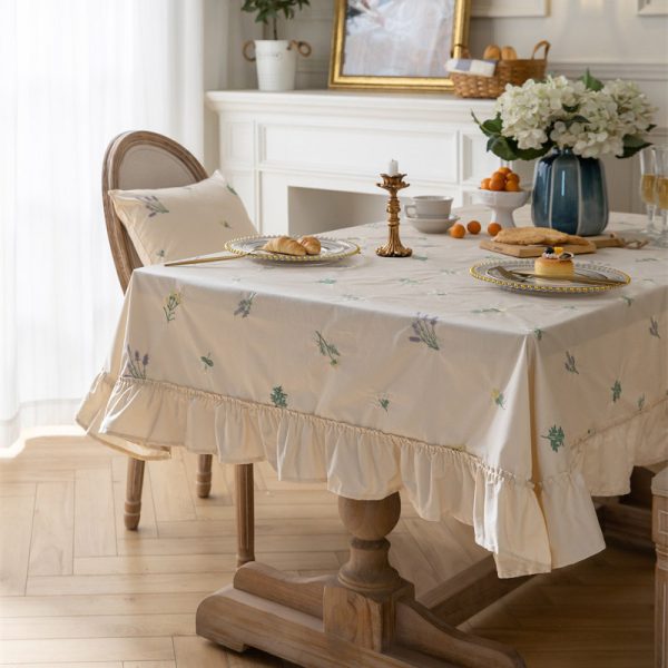 Beige cotton embroidered tablecloth with green leaf pattern and soft ruffle edges, ideal for home dining, outdoor use, or restaurant tables.