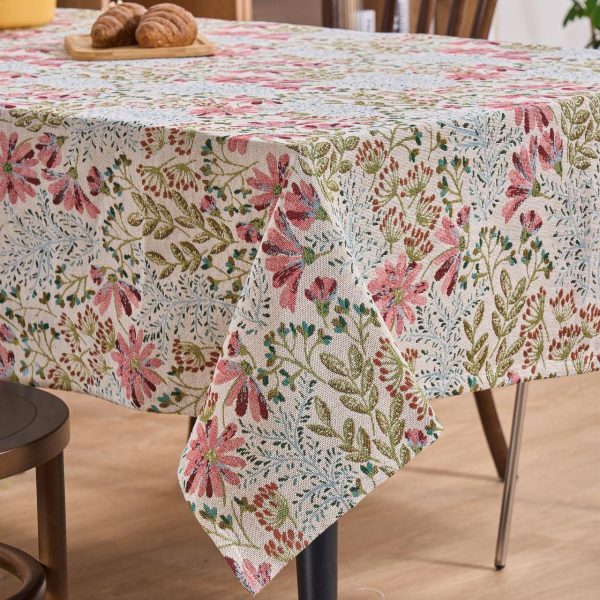 Countryside dining setup with lily-patterned tablecloth and vintage dishes