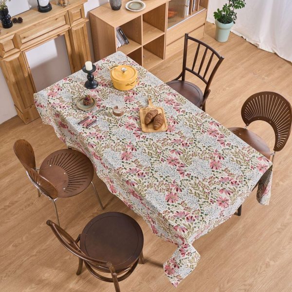 Cozy indoor meal setting featuring jacquard tablecloth and fresh flowers