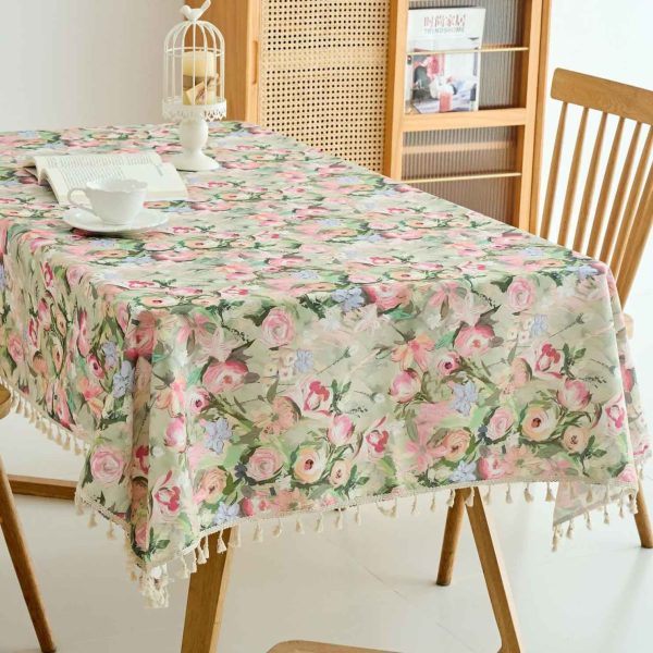 Pastoral pink floral polyester tablecloth on a rectangular wooden dining table with sunlight streaming in