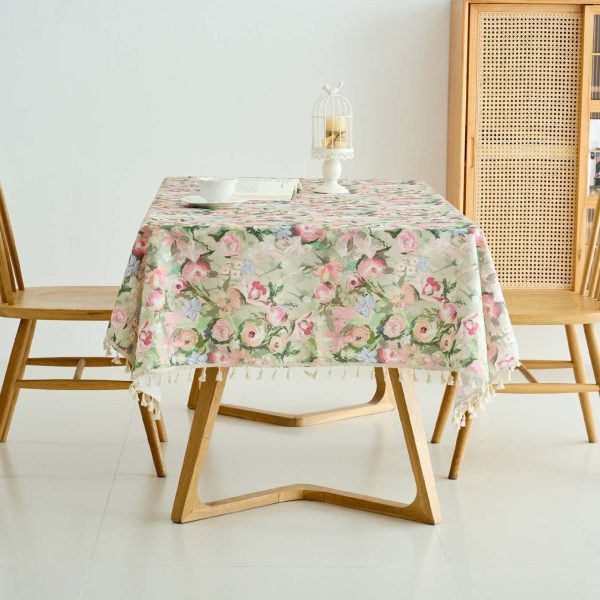 Outdoor picnic scene featuring durable and easy-care floral tablecloth in soft pink tones