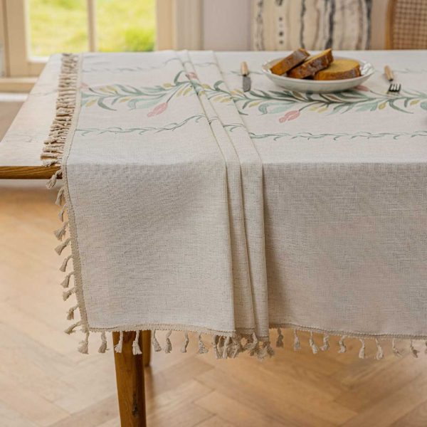 Beige faux linen tablecloth with brown embroidered leaf pattern and tassel fringe, made from polyester-linen blend, suitable for dining tables or outdoor settings.