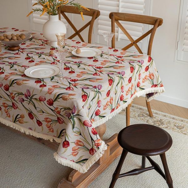 Soft cotton-linen floral tablecloth draped on an oval table set for brunch