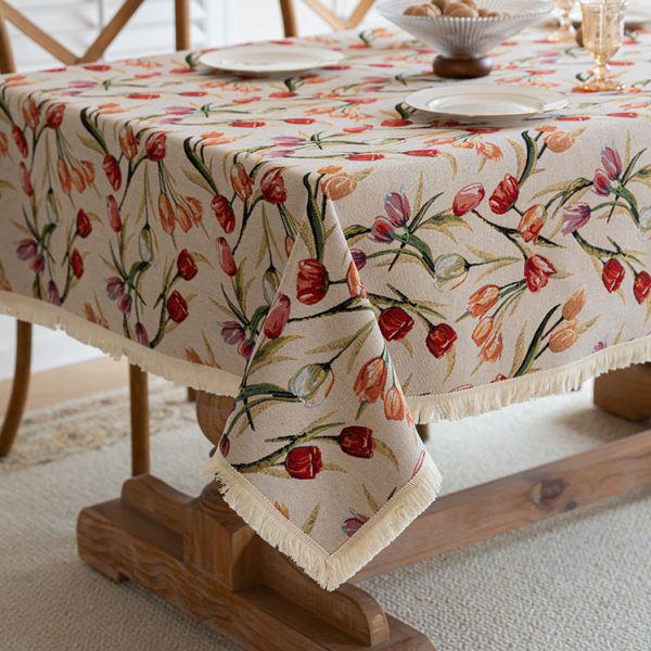 Close-up of cotton linen tablecloth with delicate tulip floral pattern in natural tones