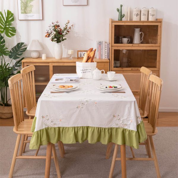 White cotton embroidered tablecloth with lemon and leaf design, featuring green ruffled edges, ideal for summer dining, outdoor picnics, or farmhouse-style kitchens.