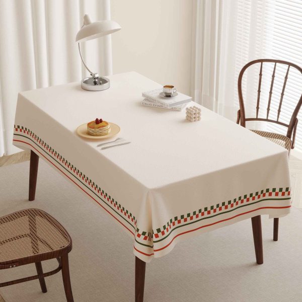 Elegant faux leather waterproof tablecloth with red and green striped border on dining table