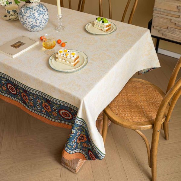 Vintage floral jacquard tablecloth in warm tones with decorative Nordic-style border, perfect for rustic or elegant dining setups.
