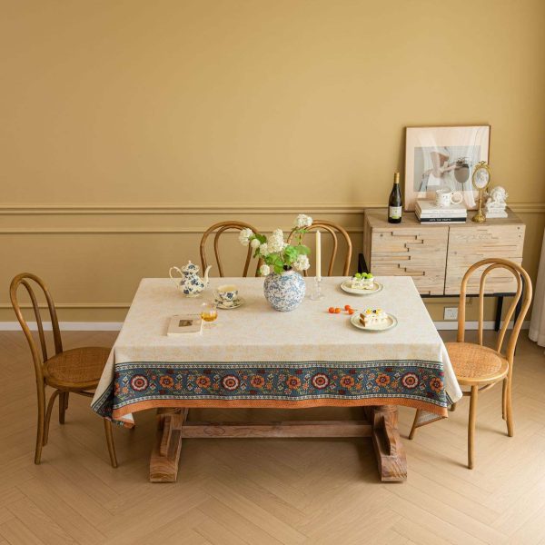 Vintage floral jacquard tablecloth in warm tones with decorative Nordic-style border, perfect for rustic or elegant dining setups.