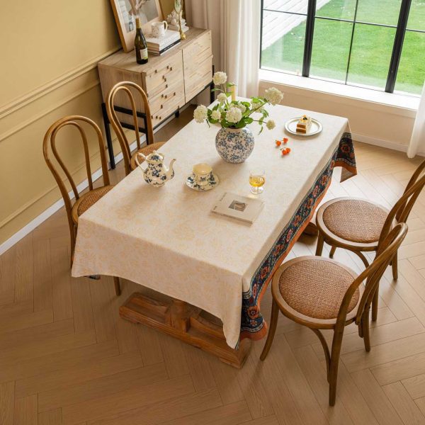 Vintage floral jacquard tablecloth in warm tones with decorative Nordic-style border, perfect for rustic or elegant dining setups.
