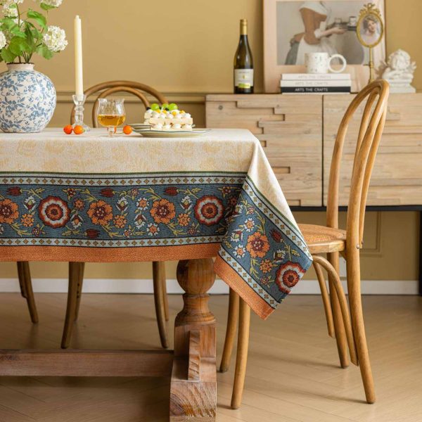Vintage floral jacquard tablecloth in warm tones with decorative Nordic-style border, perfect for rustic or elegant dining setups.