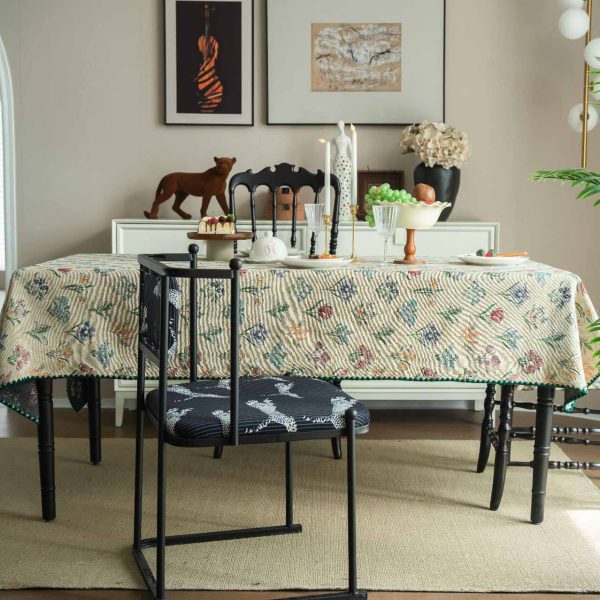 Elegant hyacinth floral jacquard tablecloth in soft beige with curved botanical design and textured finish, styled on a wooden dining table with natural light.