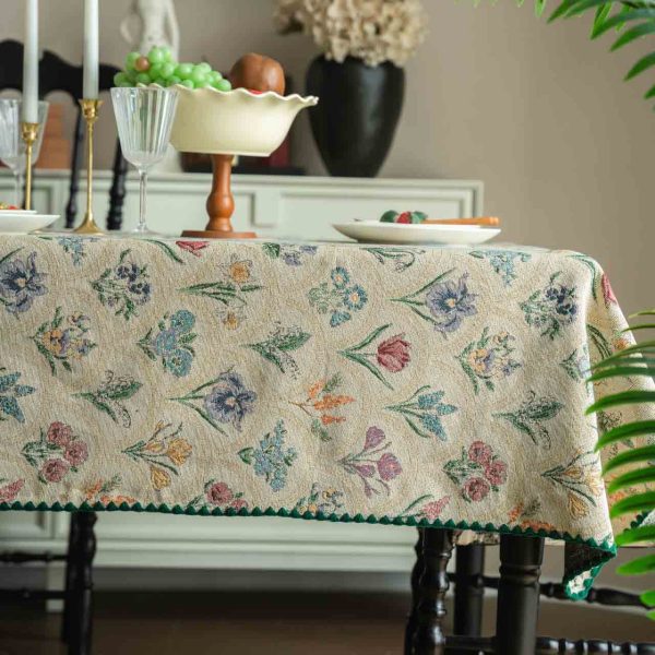 Elegant hyacinth floral jacquard tablecloth in soft beige with curved botanical design and textured finish, styled on a wooden dining table with natural light.