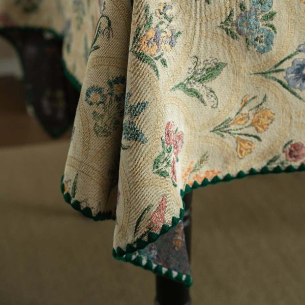 Elegant hyacinth floral jacquard tablecloth in soft beige with curved botanical design and textured finish, styled on a wooden dining table with natural light.