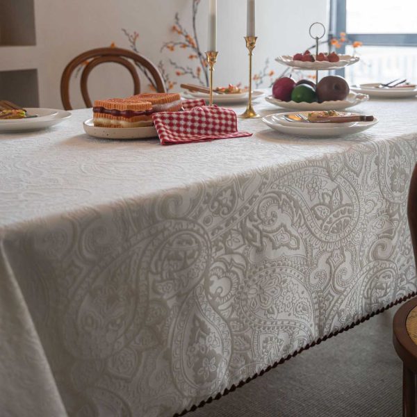 Embroidered cotton-blend tablecloth with scalloped shell edging, elegantly styled on a vintage dining table with natural light and classic tableware.
