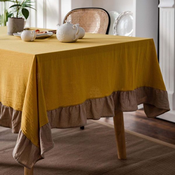 Brighten your table with this cheerful yellow cotton tablecloth featuring soft ruffle trim. Farmhouse charm meets easy elegance. Machine washable and perfect for daily use.