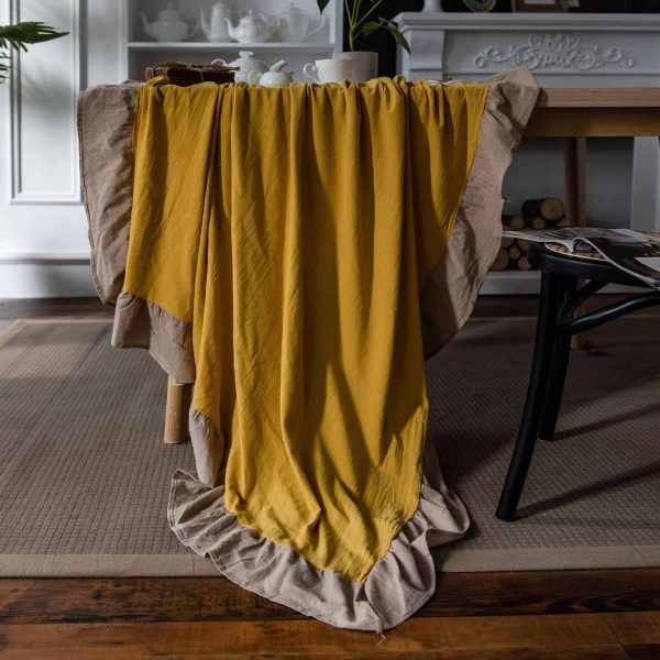 Brighten your table with this cheerful yellow cotton tablecloth featuring soft ruffle trim. Farmhouse charm meets easy elegance. Machine washable and perfect for daily use.