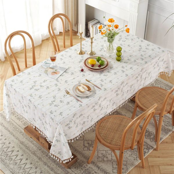 White cotton embroidered tablecloth with floral and leaf designs, finished with tassel fringe – elegant and soft table decor for dining or outdoor use.