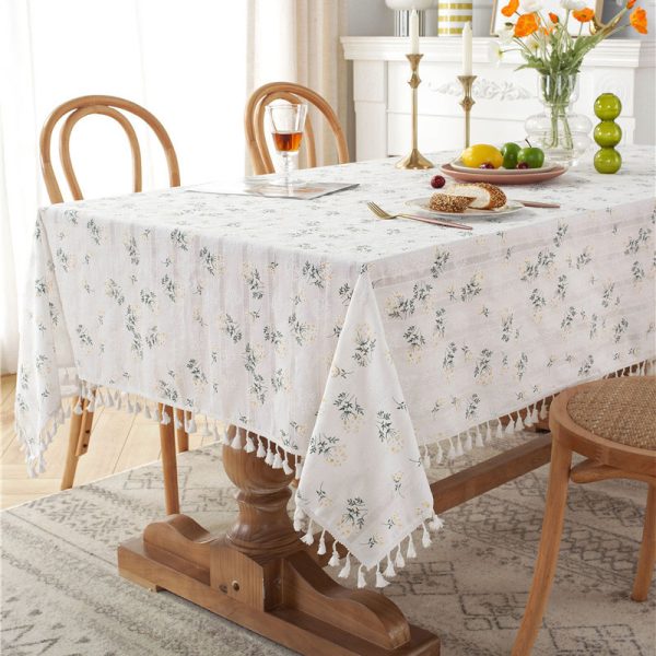 White cotton embroidered tablecloth with floral and leaf designs, finished with tassel fringe – elegant and soft table decor for dining or outdoor use.