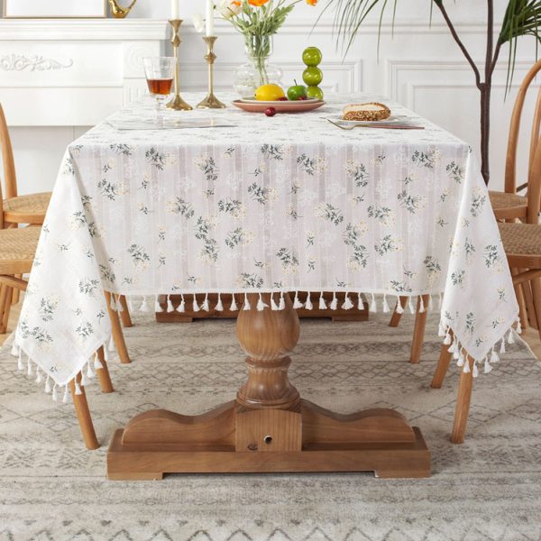 White cotton embroidered tablecloth with floral and leaf designs, finished with tassel fringe – elegant and soft table decor for dining or outdoor use.