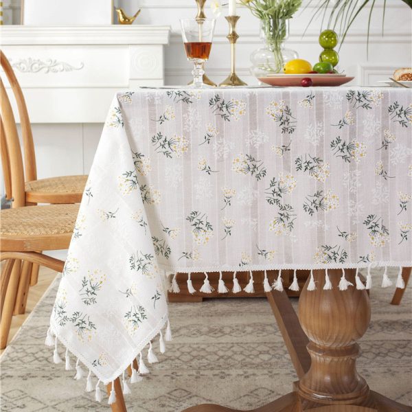White cotton embroidered tablecloth with floral and leaf designs, finished with tassel fringe – elegant and soft table decor for dining or outdoor use.
