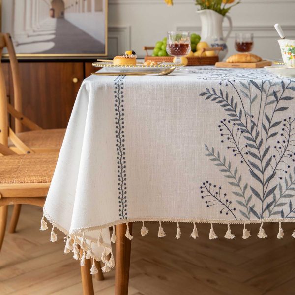 Close-up view of embroidered wild fern design on faux linen fabric with tassel edge