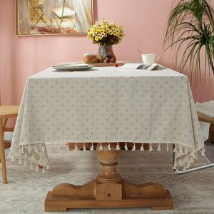 Vintage blue floral cotton linen tablecloth with tassels on dining table