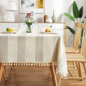 Outdoor picnic setting with striped table cover and rustic dinnerware