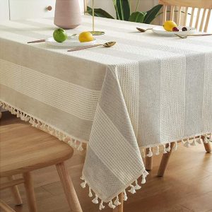 Minimalist dining room featuring striped linen tablecloth on rectangular table