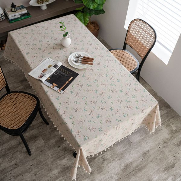 Elegant vintage-style dining setup with soft floral tablecloth