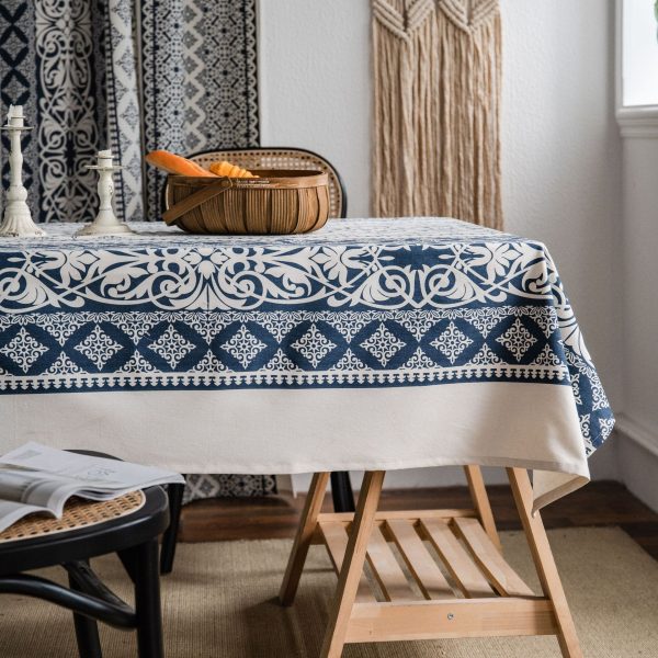 Blue and white vintage table linens with floral print on a rustic table