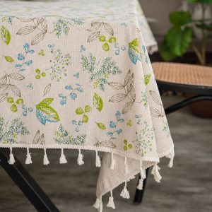 Tassel-edged vintage linen tablecloth on outdoor garden table