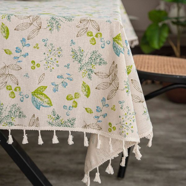 Tassel-edged vintage linen tablecloth on outdoor garden table