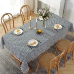 Dining table styled with antique table linens and plants