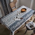 Elegant vintage blue tablecloth with floral pattern on a dining table