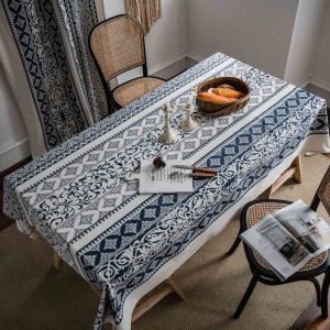 Elegant vintage blue tablecloth with floral pattern on a dining table