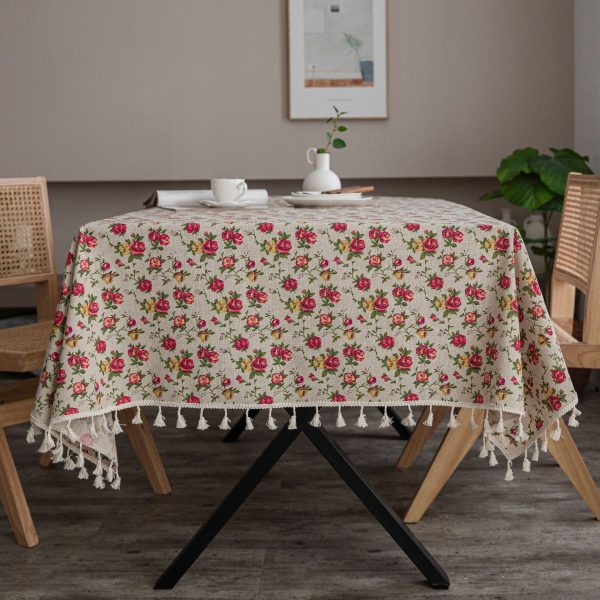 Romantic dining table styled with a floral cloth tablecloth and vintage plates