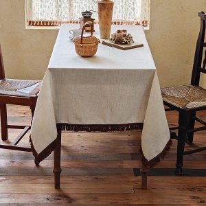 Vintage-style tablecloth paired with woven baskets and mugs
