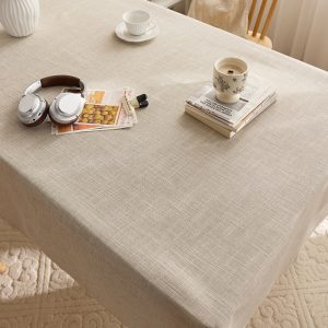Retro style beige tablecloth setting with fall-themed decorations