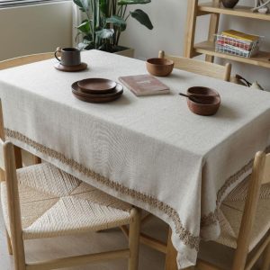 Natural linen table linens draped on a farmhouse table