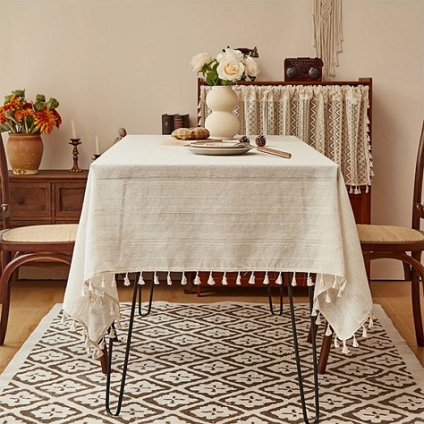 Vintage-inspired white tablecloth styled in farmhouse dining setting