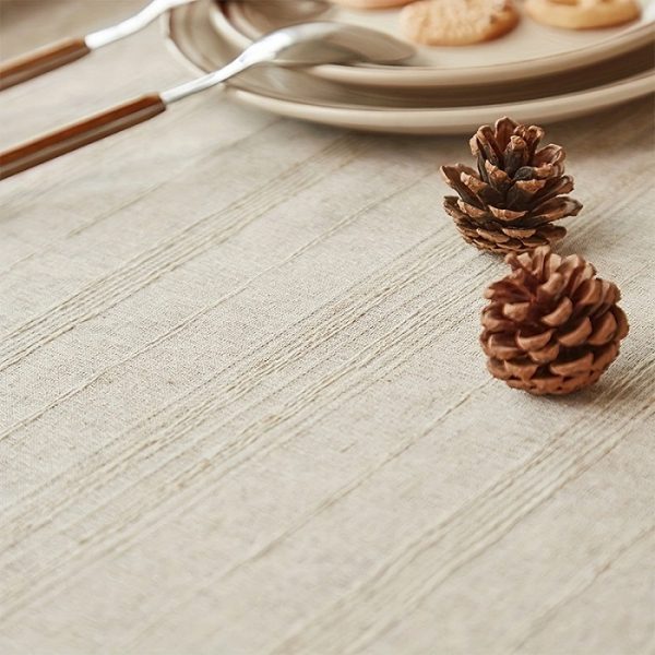 Close-up of natural linen texture with handcrafted fringe detail