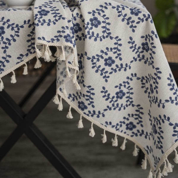 Close-up of soft cotton-linen texture and floral embroidery on tablecloth