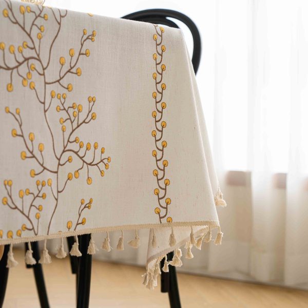 Rustic berry-embroidered tablecloth used outdoors for a picnic setting